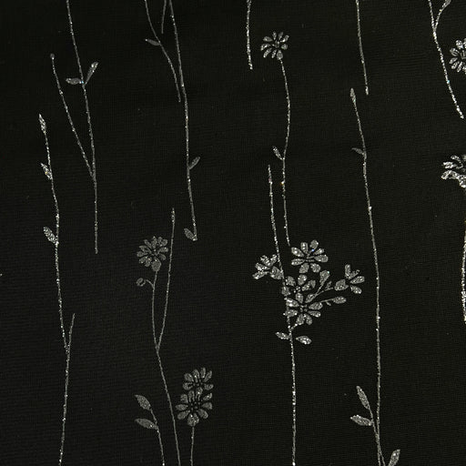 Black fabric with delicate silver floral and vine embroidery.