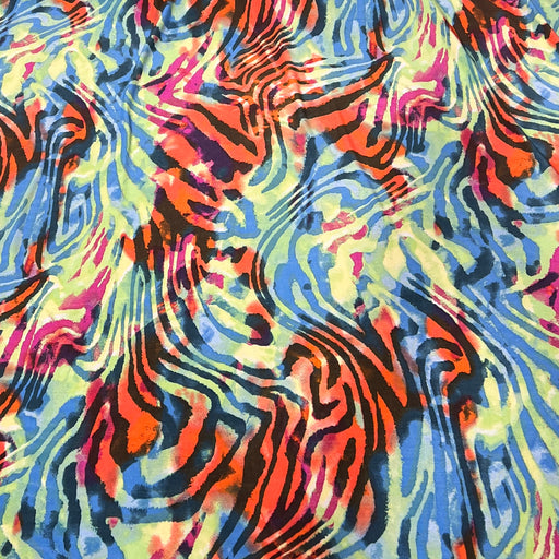 A close-up of a vibrant, multicolored abstract pattern featuring swirling, wavy lines in blue, orange, pink, yellow, and black.