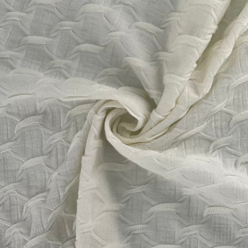 Close-up of textured white fabric with a subtle pattern