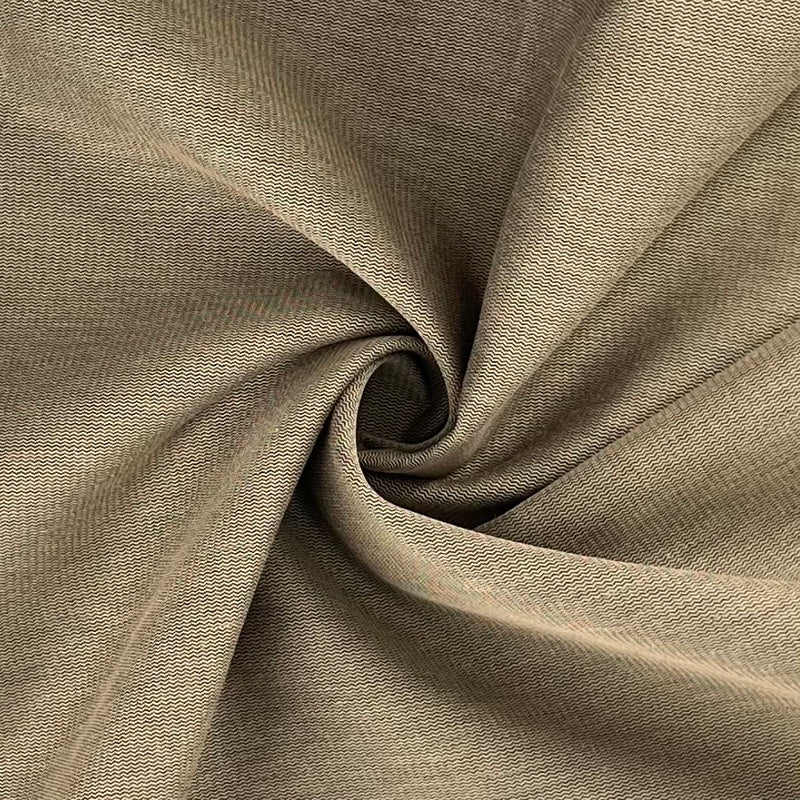 Closeup of khaki and black broken twill zig-zag suiting folded into a swirl. 